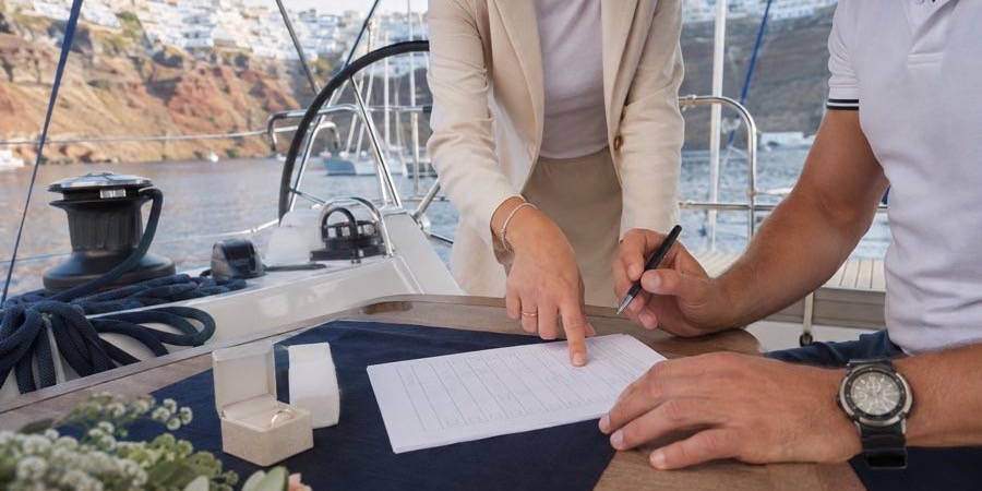 Intimate wedding ceremony on a sailing yacht near Santorini, Greece