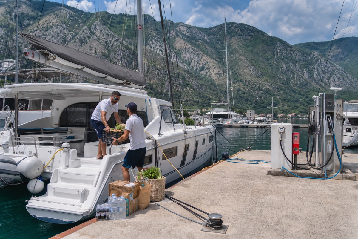 Provisioning and fuel service beside a yacht in the Bay of Kotor