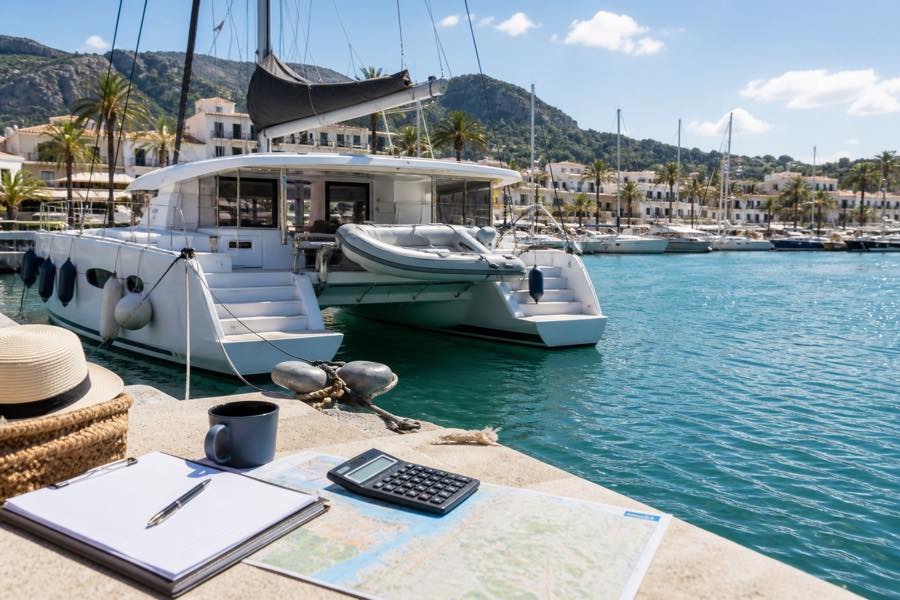 Catamaran in a Balearic marina with a charter budget plan